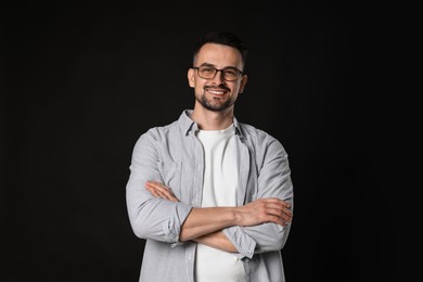 Photo of Portrait of handsome middle aged man on black background