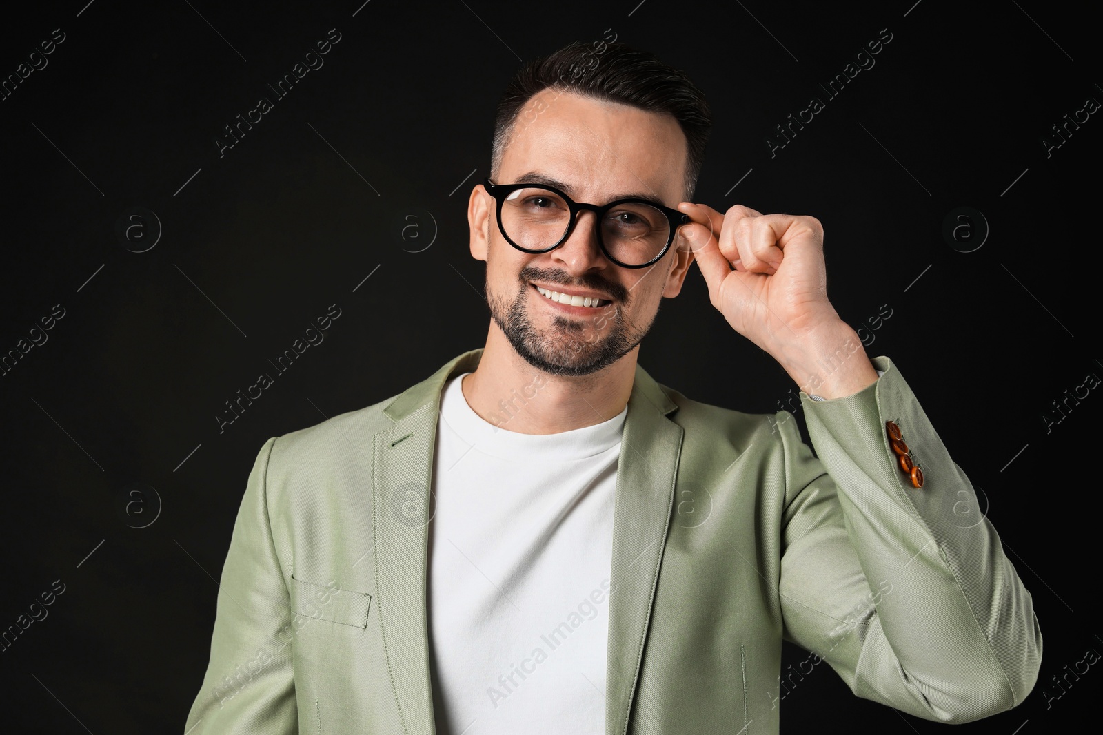 Photo of Portrait of handsome middle aged man on black background