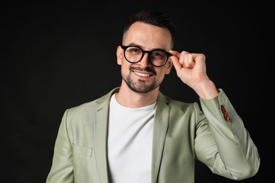 Photo of Portrait of handsome middle aged man on black background