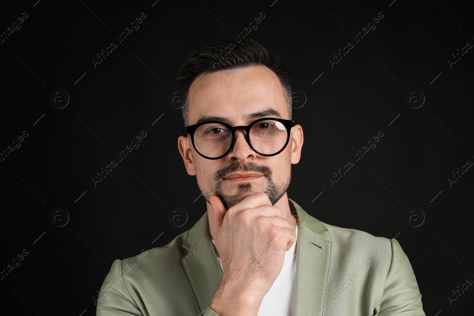 Photo of Portrait of handsome middle aged man on black background