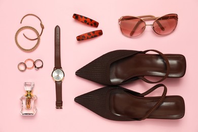 Photo of Many stylish jewelry, shoes, perfume and accessories on pink background, flat lay