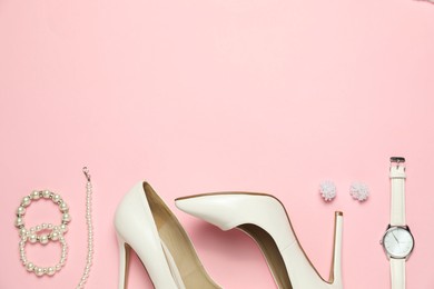 Photo of Many stylish jewelry, shoes and accessories on pink background, flat lay. Space for text