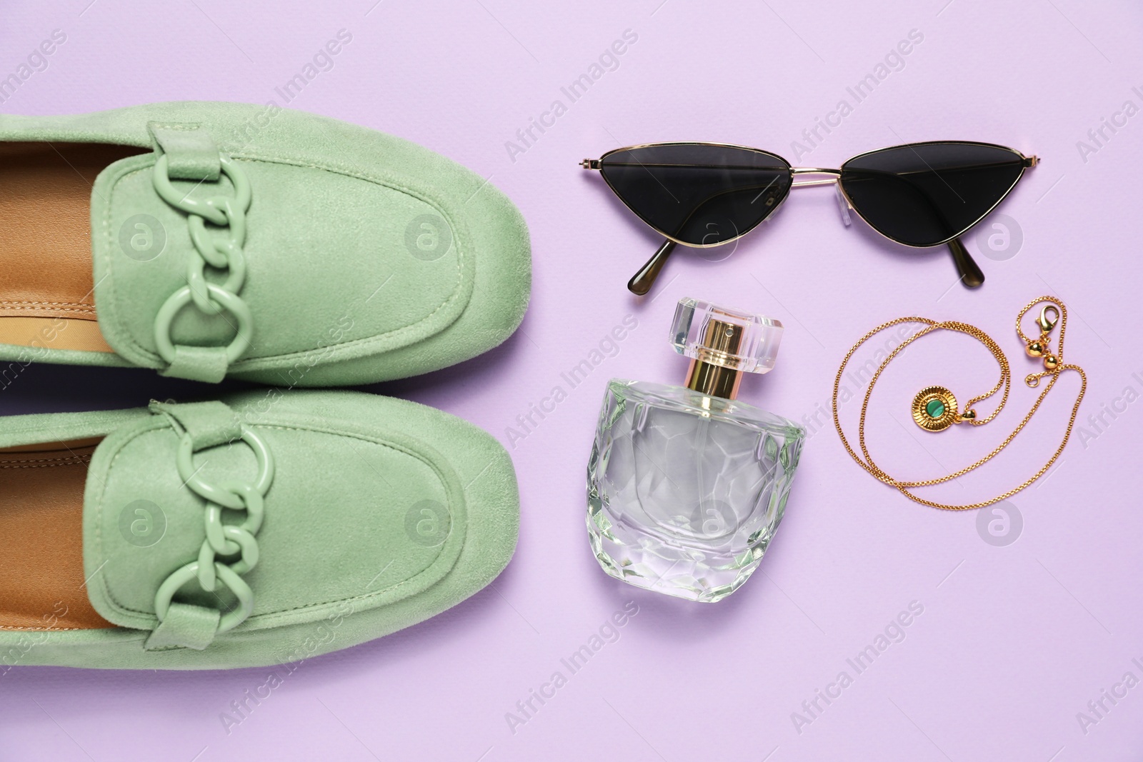 Photo of Many stylish necklace, shoes, perfume and sunglasses on violet background, flat lay