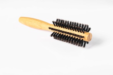 Photo of Hairdresser tool. Round wooden brush on white background