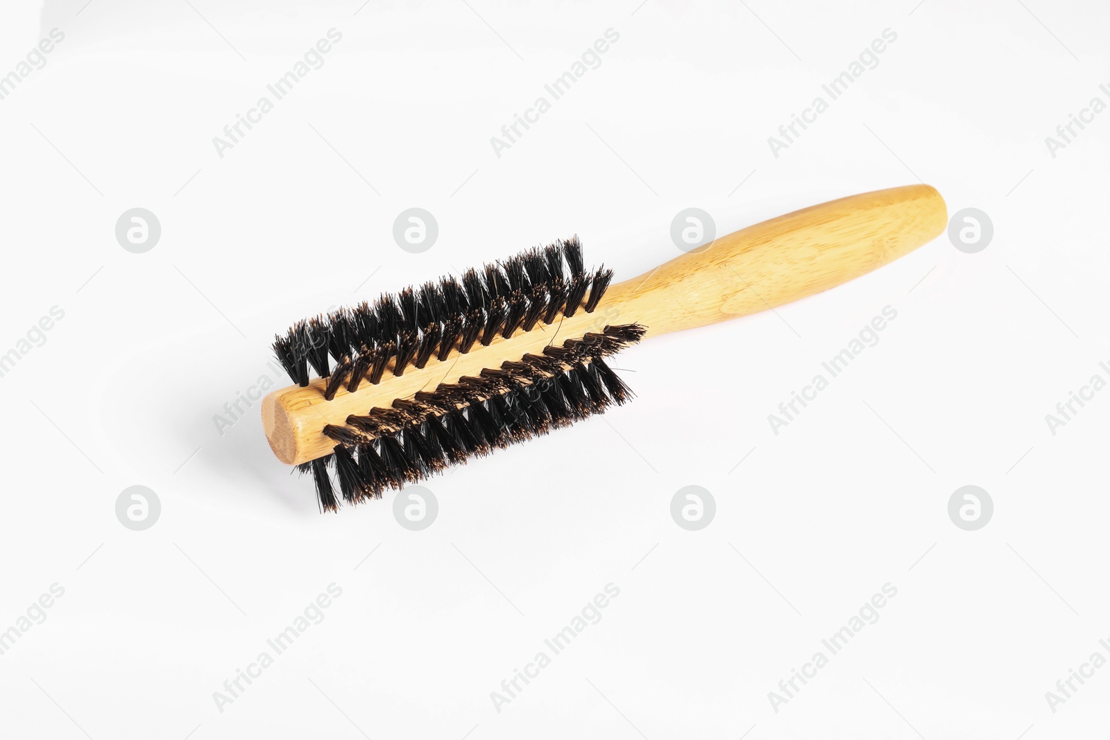 Photo of Hairdresser tool. Round wooden brush on white background