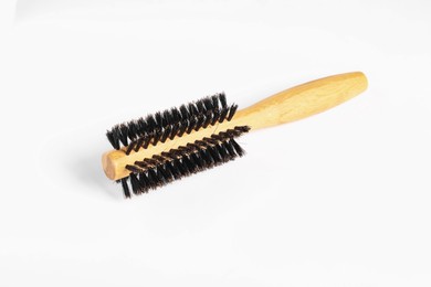 Photo of Hairdresser tool. Round wooden brush on white background