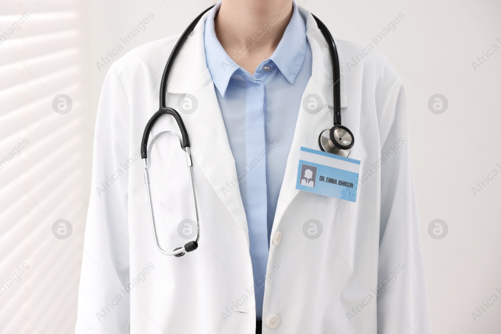 Photo of Doctor with badge in clinic, closeup view