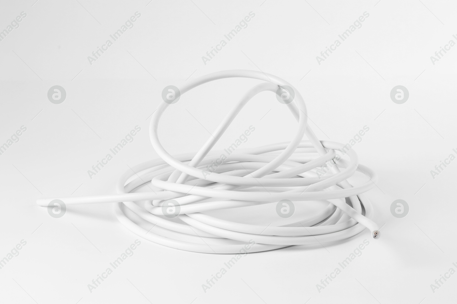 Photo of Tangled insulated electrical wire isolated on white