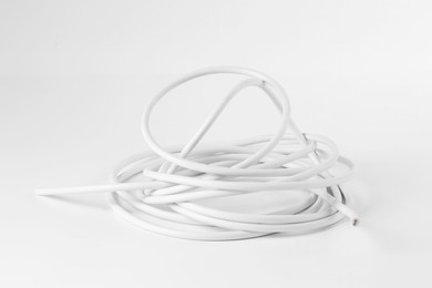 Photo of Tangled insulated electrical wire isolated on white