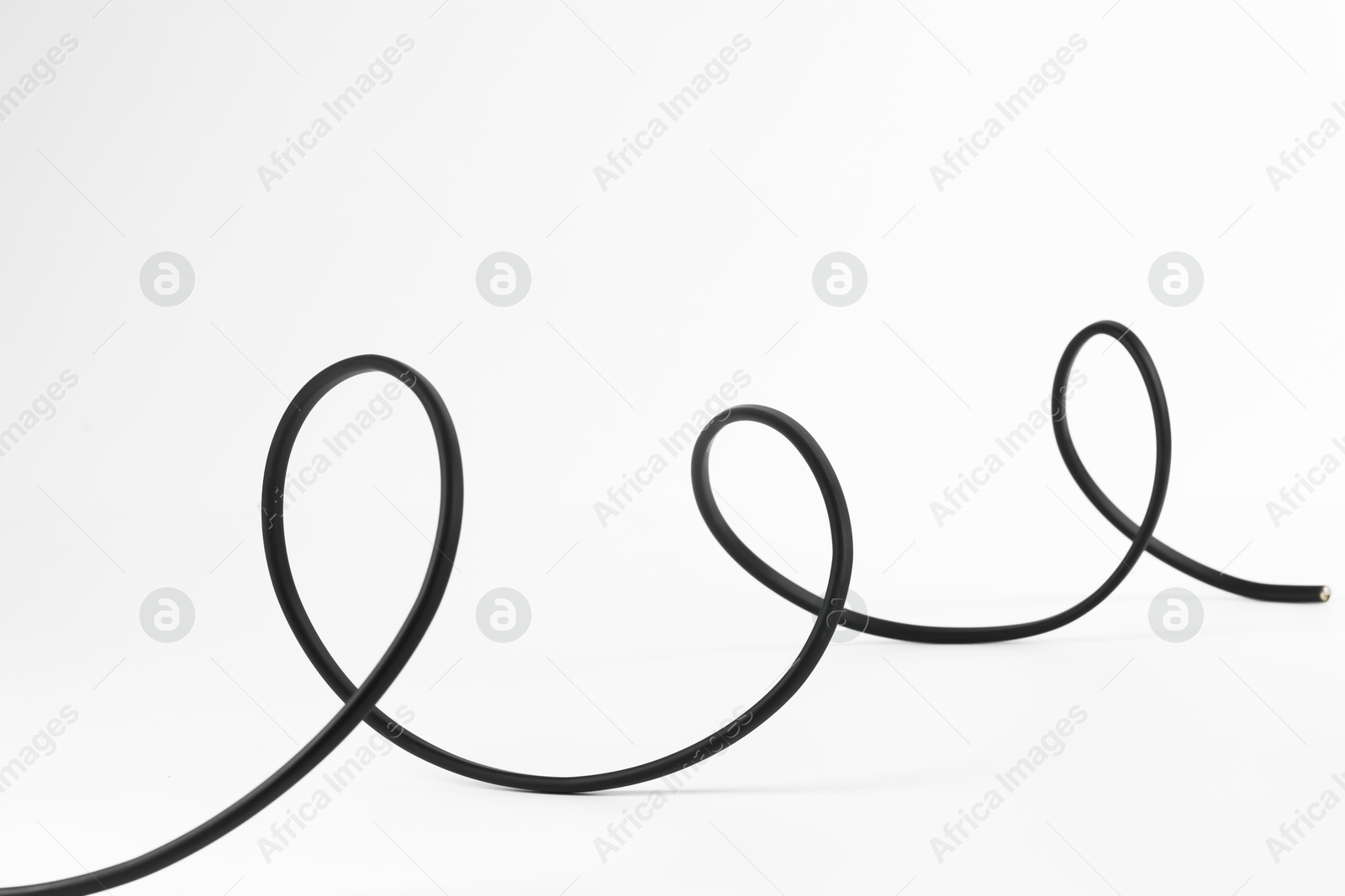 Photo of One black electrical wire isolated on white