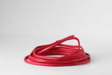 Photo of Insulated red electrical wire isolated on white