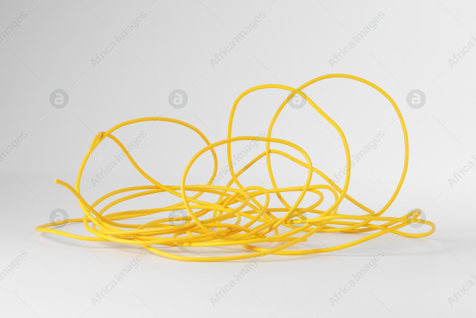 Photo of Insulated yellow electrical wire isolated on white