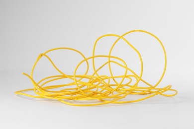 Photo of Insulated yellow electrical wire isolated on white