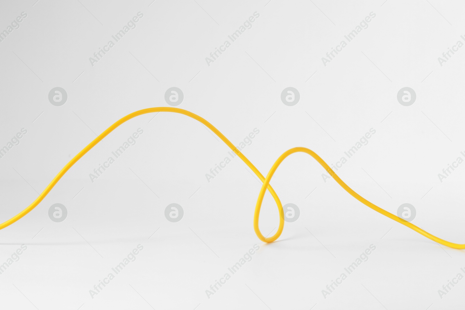 Photo of One yellow electrical wire isolated on white