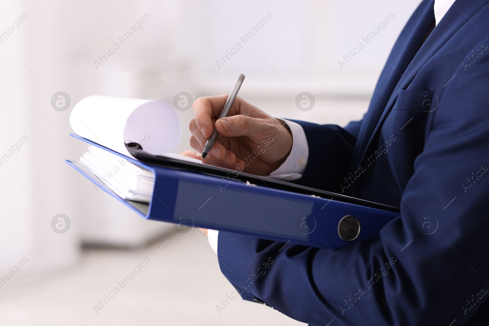 Photo of Real estate appraisal. Inspector with clipboard conducting property valuation indoors, closeup