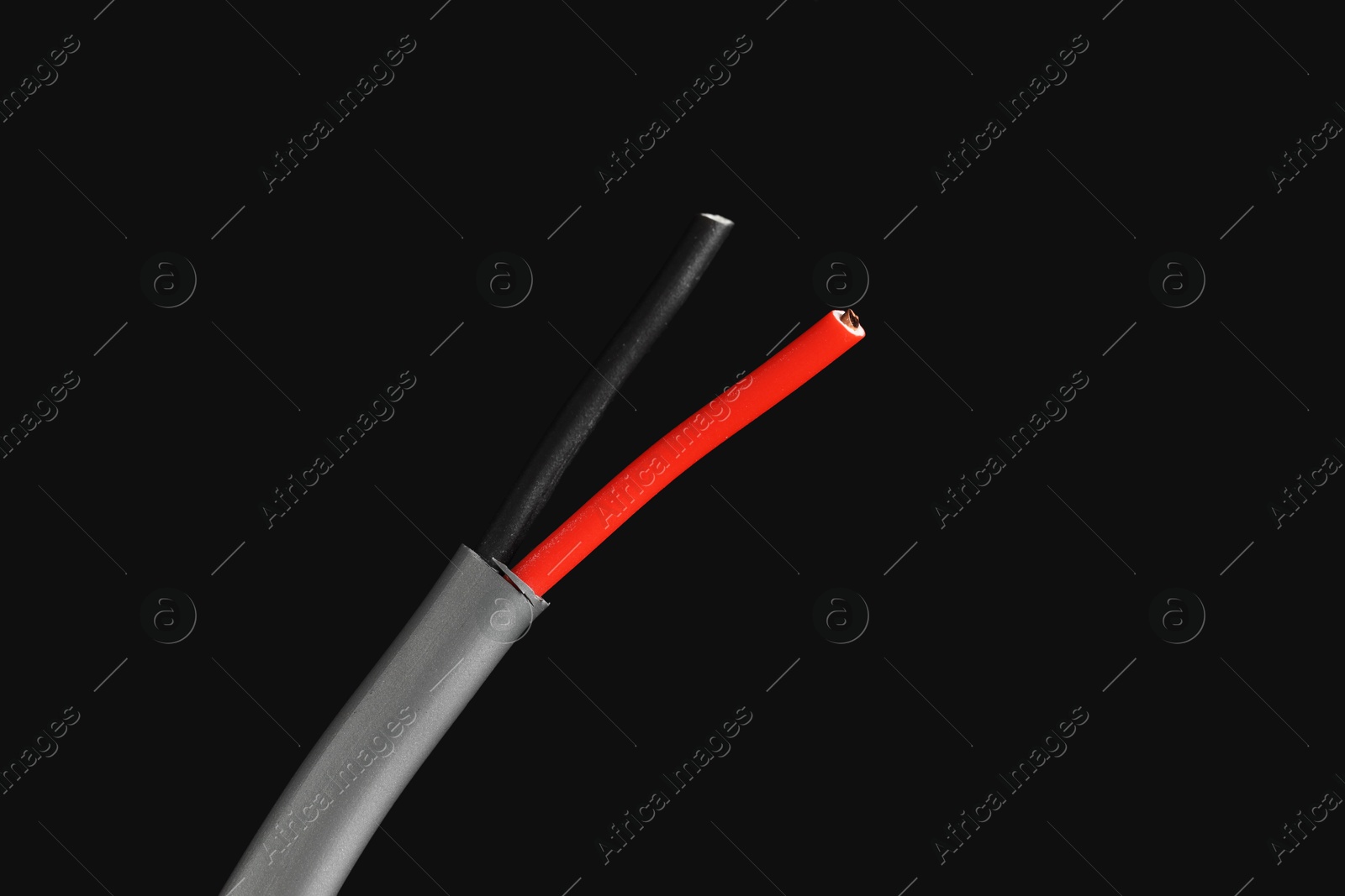 Photo of Grey stripped electrical wire on black background, closeup