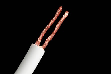 Photo of White stripped electrical wire on black background, closeup