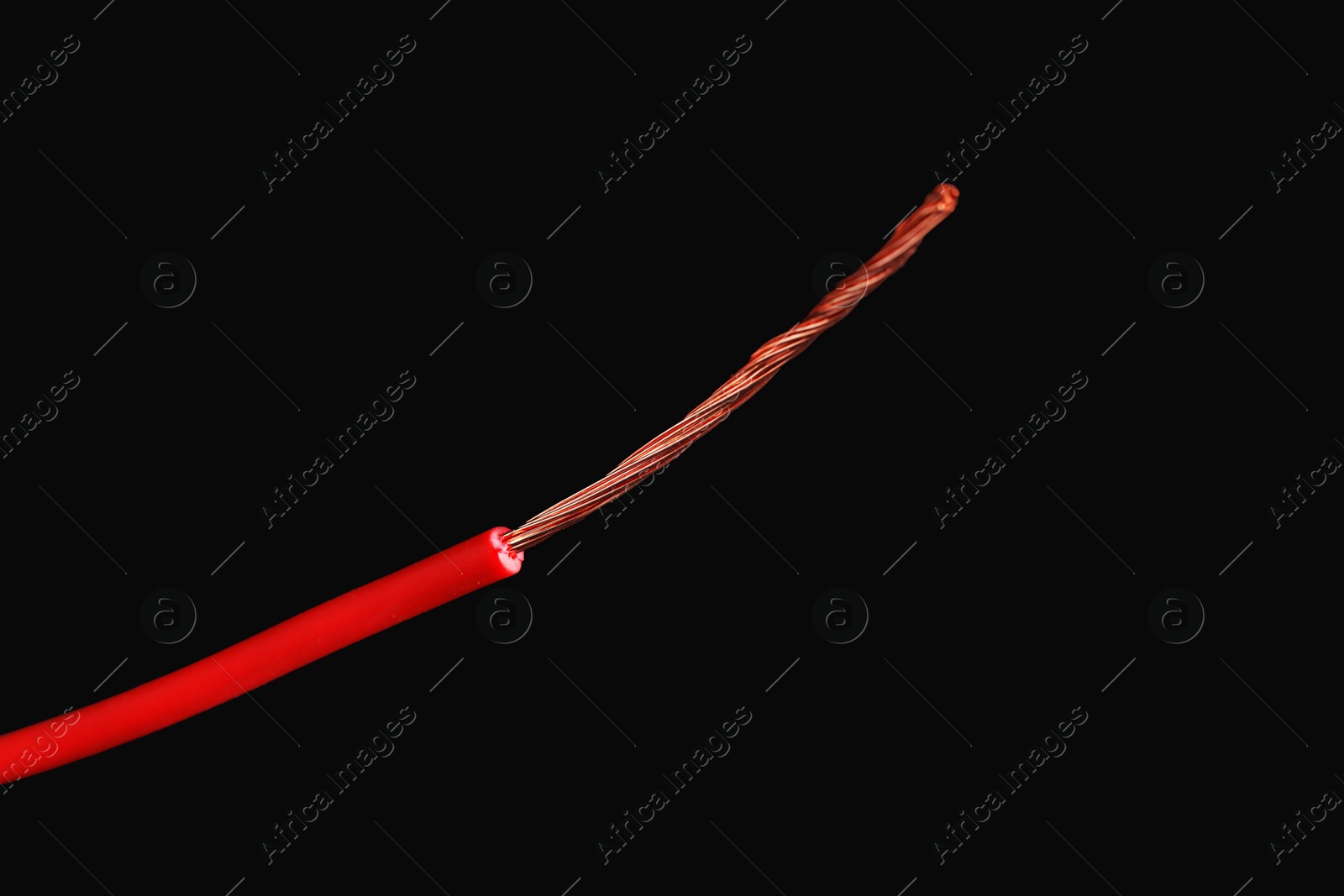 Photo of Red stripped electrical wire on black background, closeup