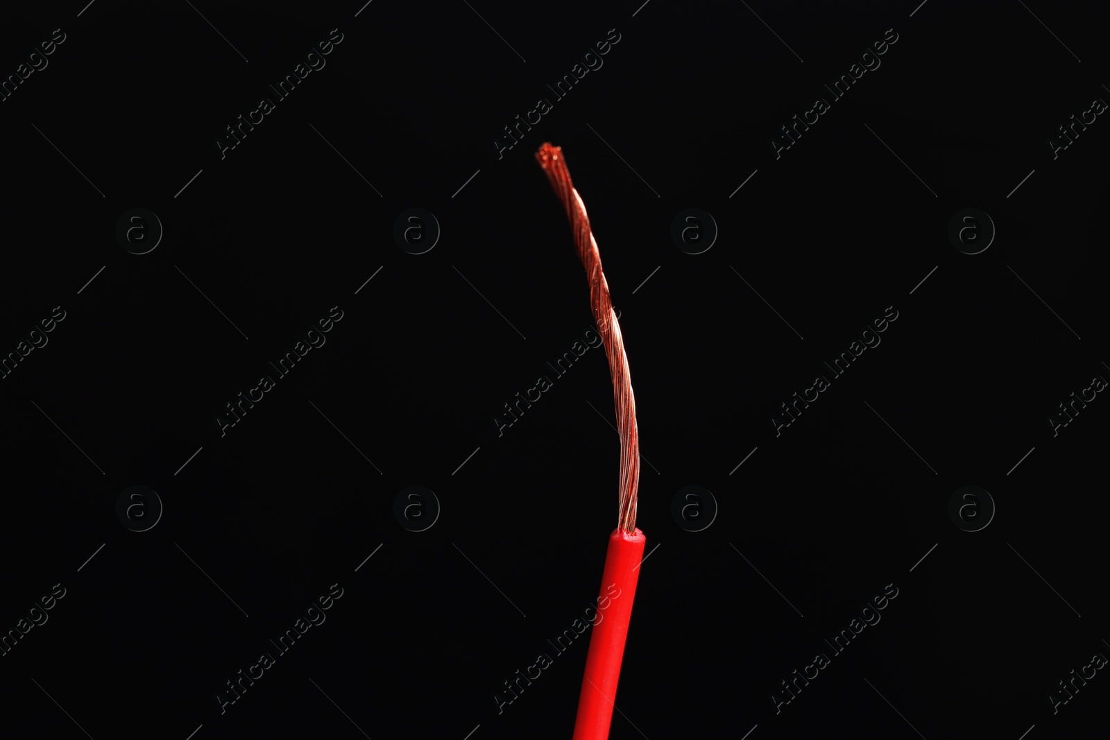 Photo of Red stripped electrical wire on black background, closeup