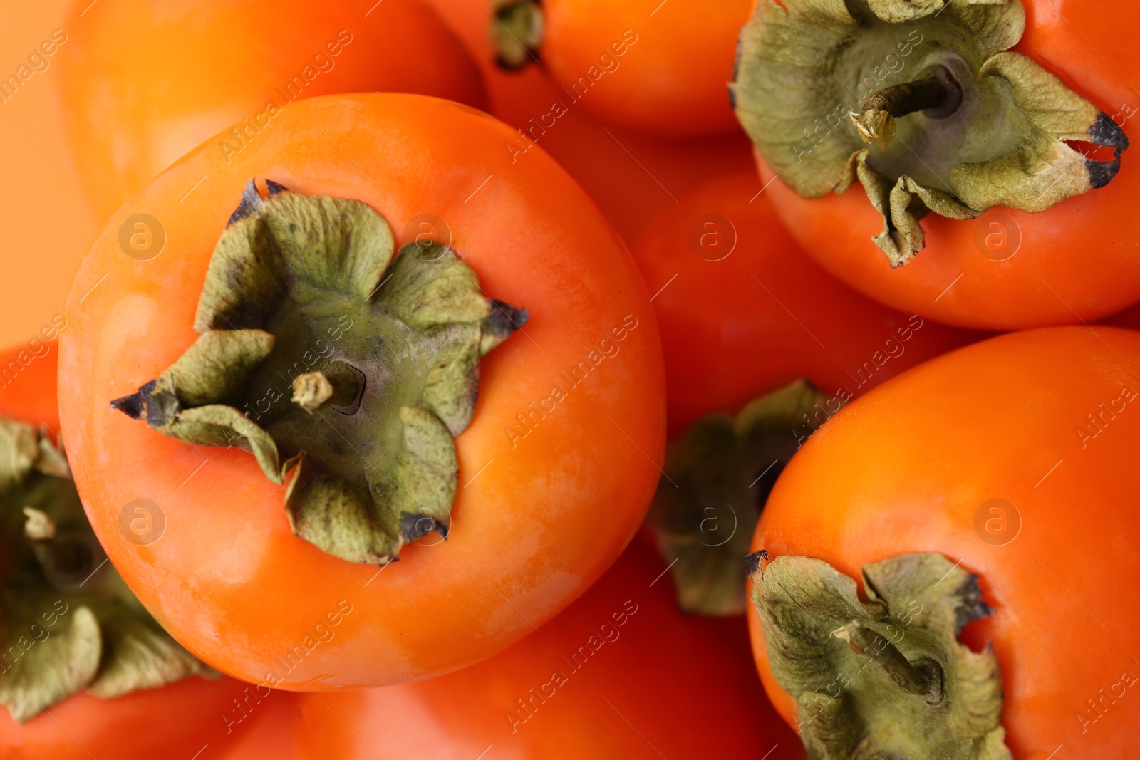 Photo of Delicious fresh juicy persimmons as background, closeup