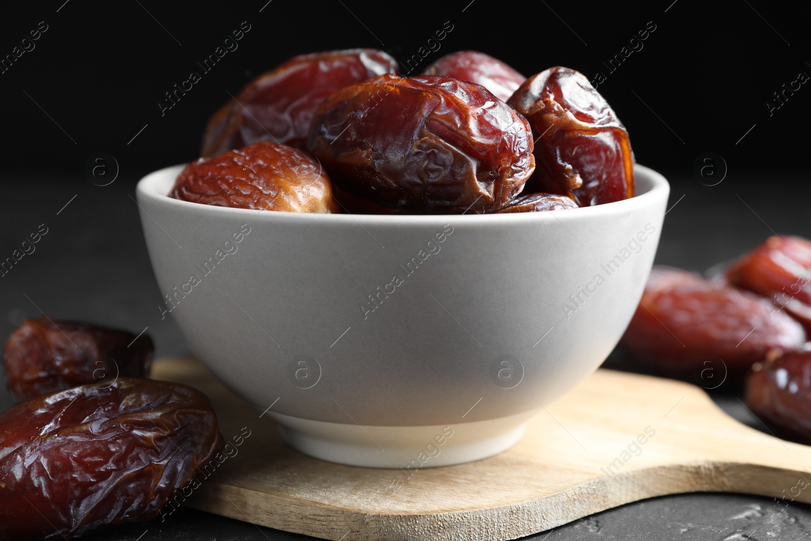 Photo of Tasty dried dates on grey table, closeup