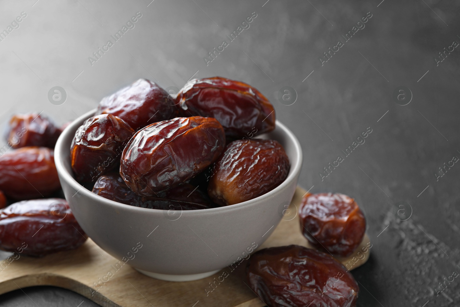 Photo of Tasty dried dates on grey table, closeup