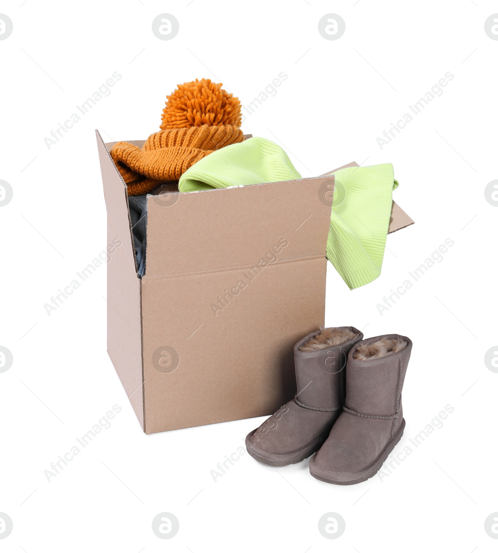 Photo of Different used clothes in box and boots isolated on white