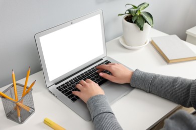 Photo of Woman working on computer at desk indoors, closeup