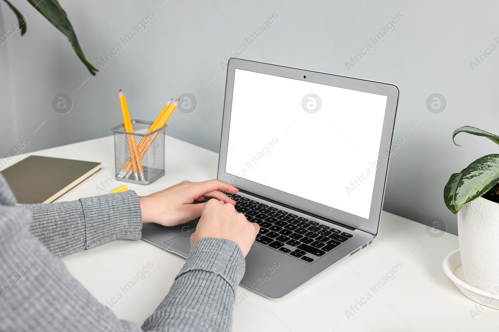 Photo of Woman working on computer at desk indoors, closeup