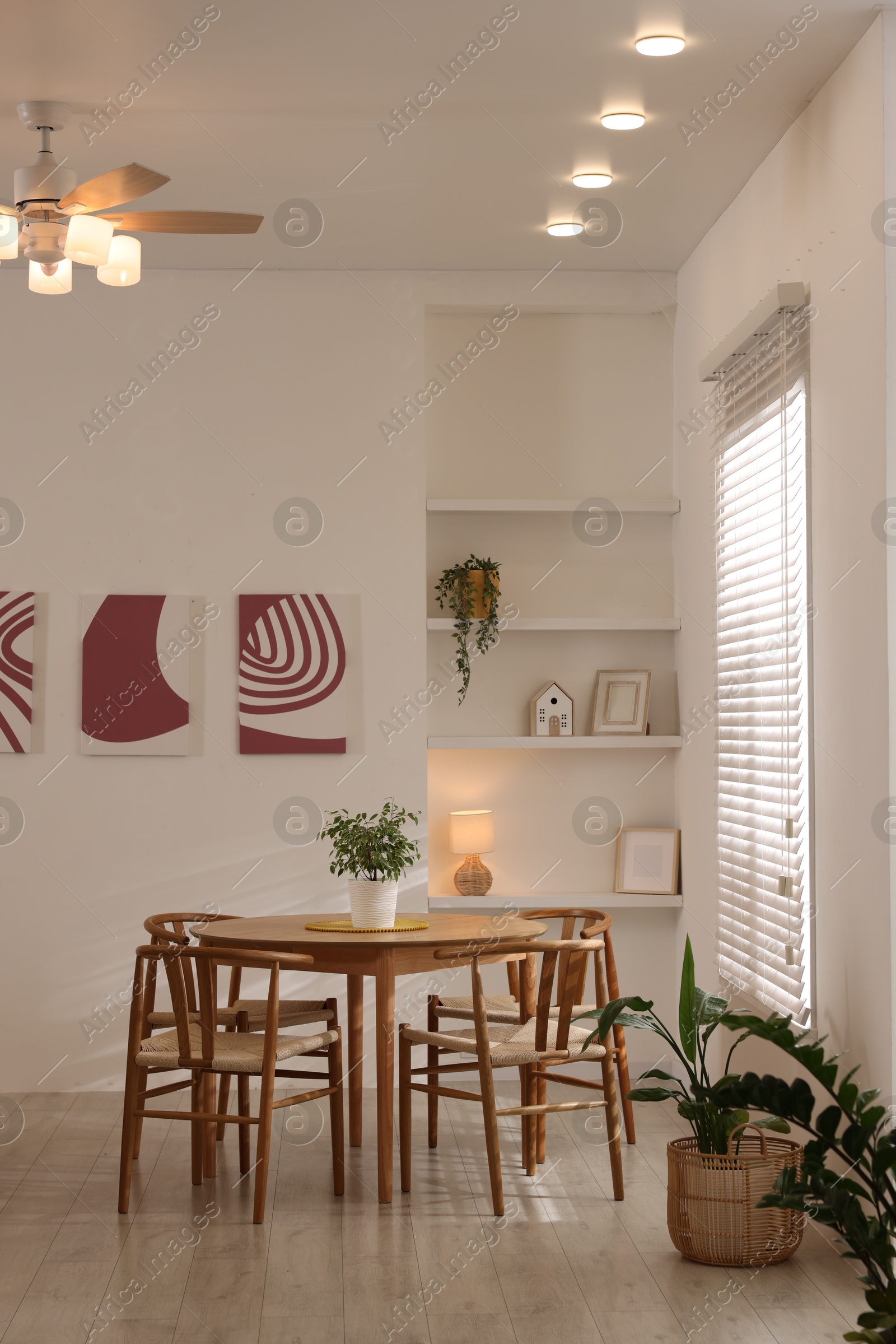 Photo of Stylish wooden table with chairs and decor indoors. Interior design