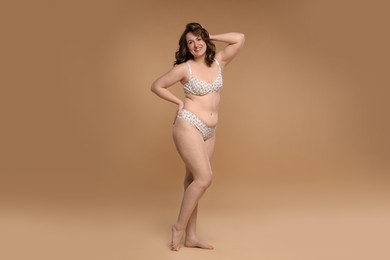 Photo of Beautiful woman in underwear on dark beige background. Cellulite problem