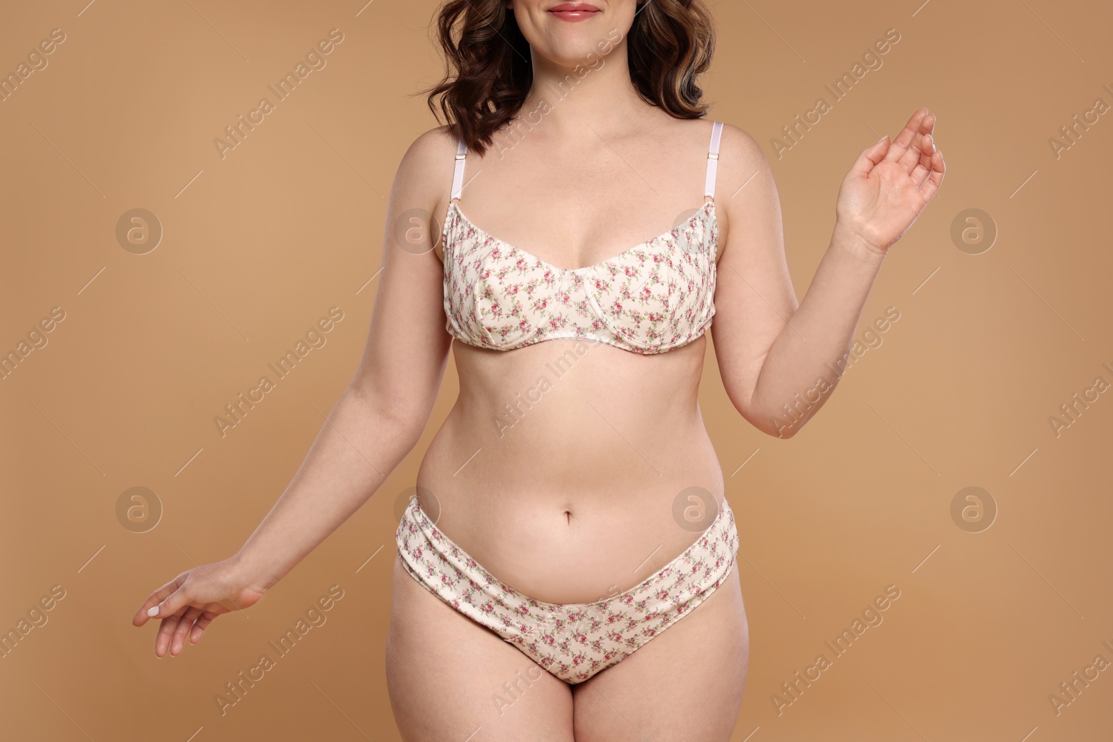 Photo of Woman with cellulite on dark beige background, closeup