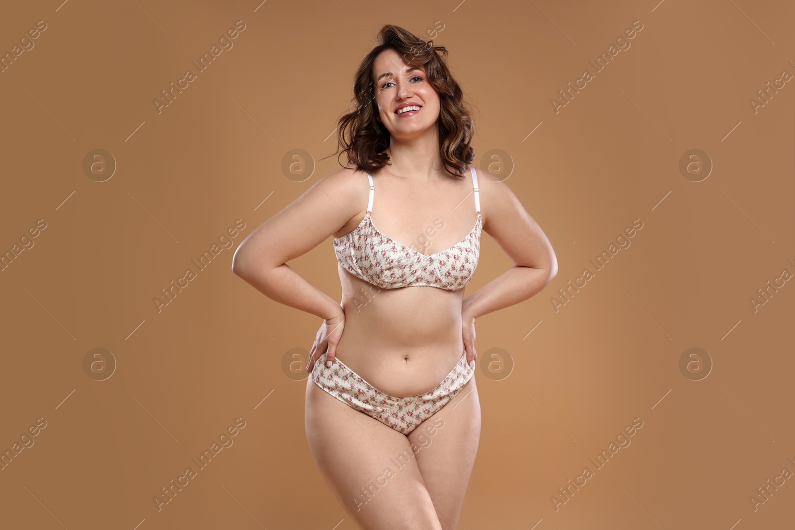 Photo of Beautiful woman in underwear on dark beige background. Cellulite problem