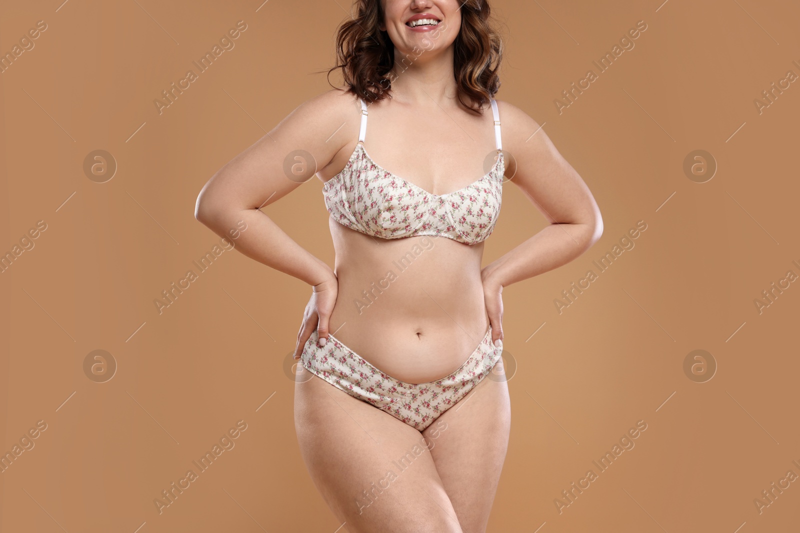 Photo of Beautiful woman in underwear on dark beige background, closeup. Cellulite problem