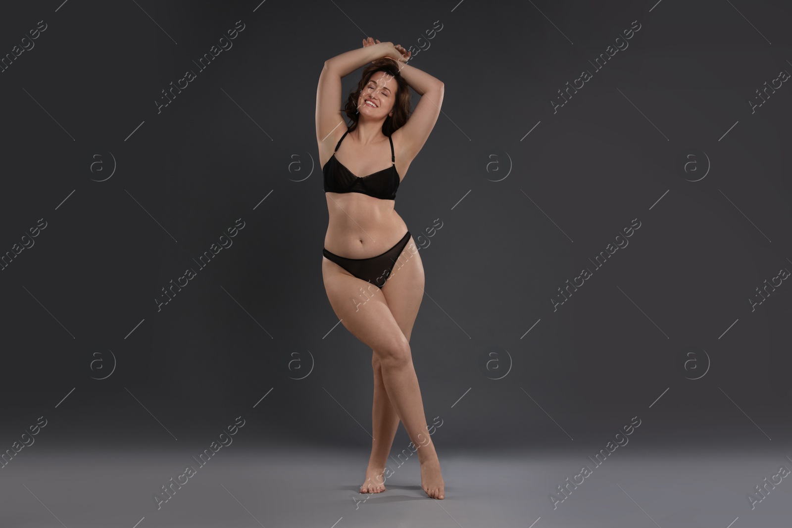 Photo of Beautiful woman in underwear on dark grey background. Cellulite problem