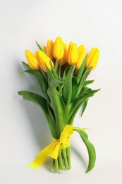 Photo of Bouquet of beautiful yellow tulips on white background, top view