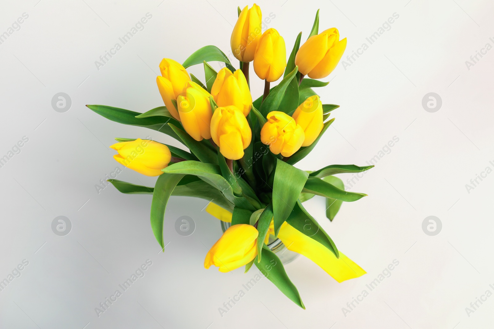 Photo of Bouquet of beautiful yellow tulips on white background, top view