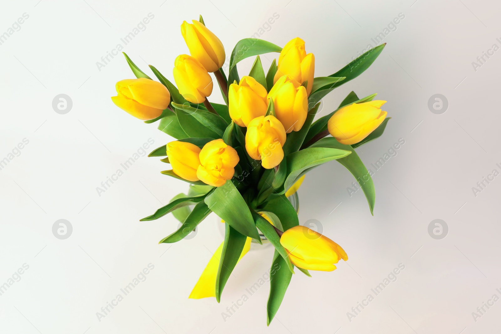 Photo of Bouquet of beautiful yellow tulips on white background, top view