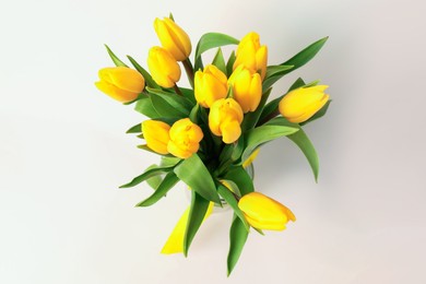 Photo of Bouquet of beautiful yellow tulips on white background, top view