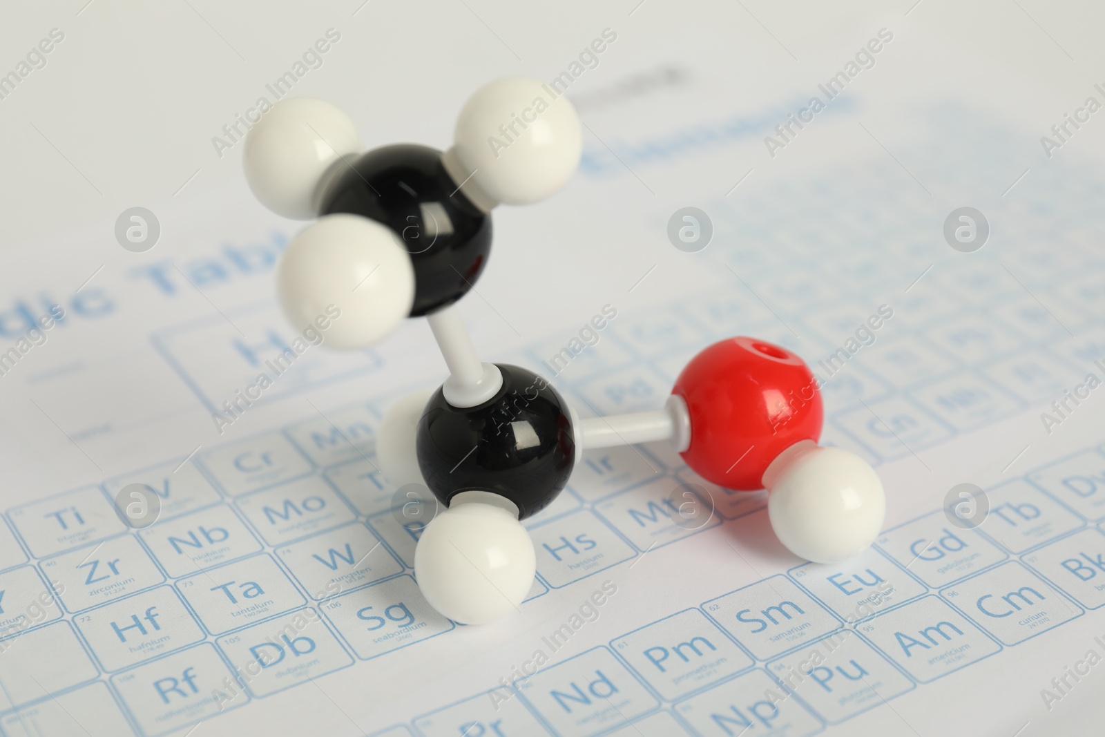 Photo of Molecule of ethanol on periodic table, closeup. Chemical model