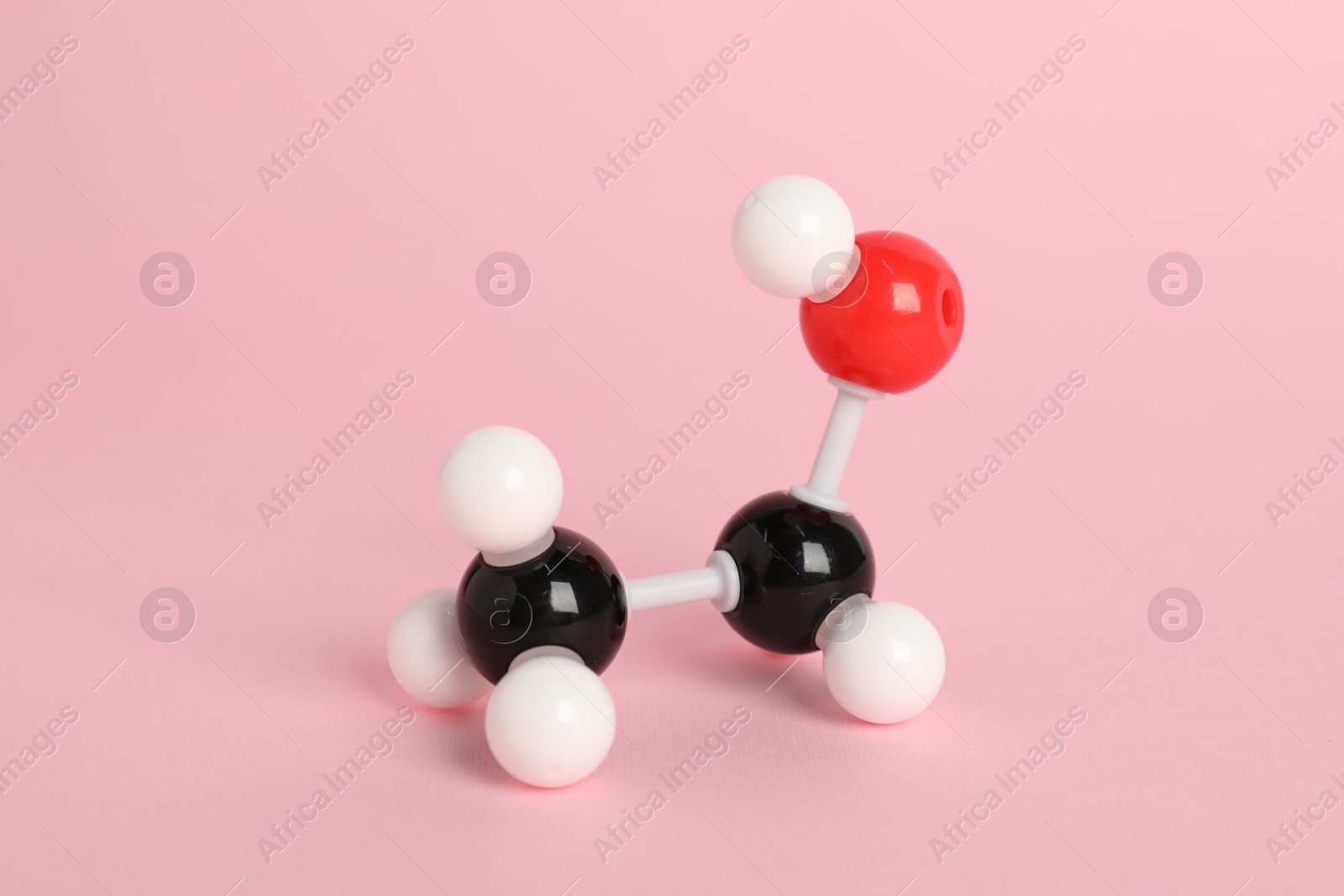 Photo of Molecule of ethanol on pink background. Chemical model