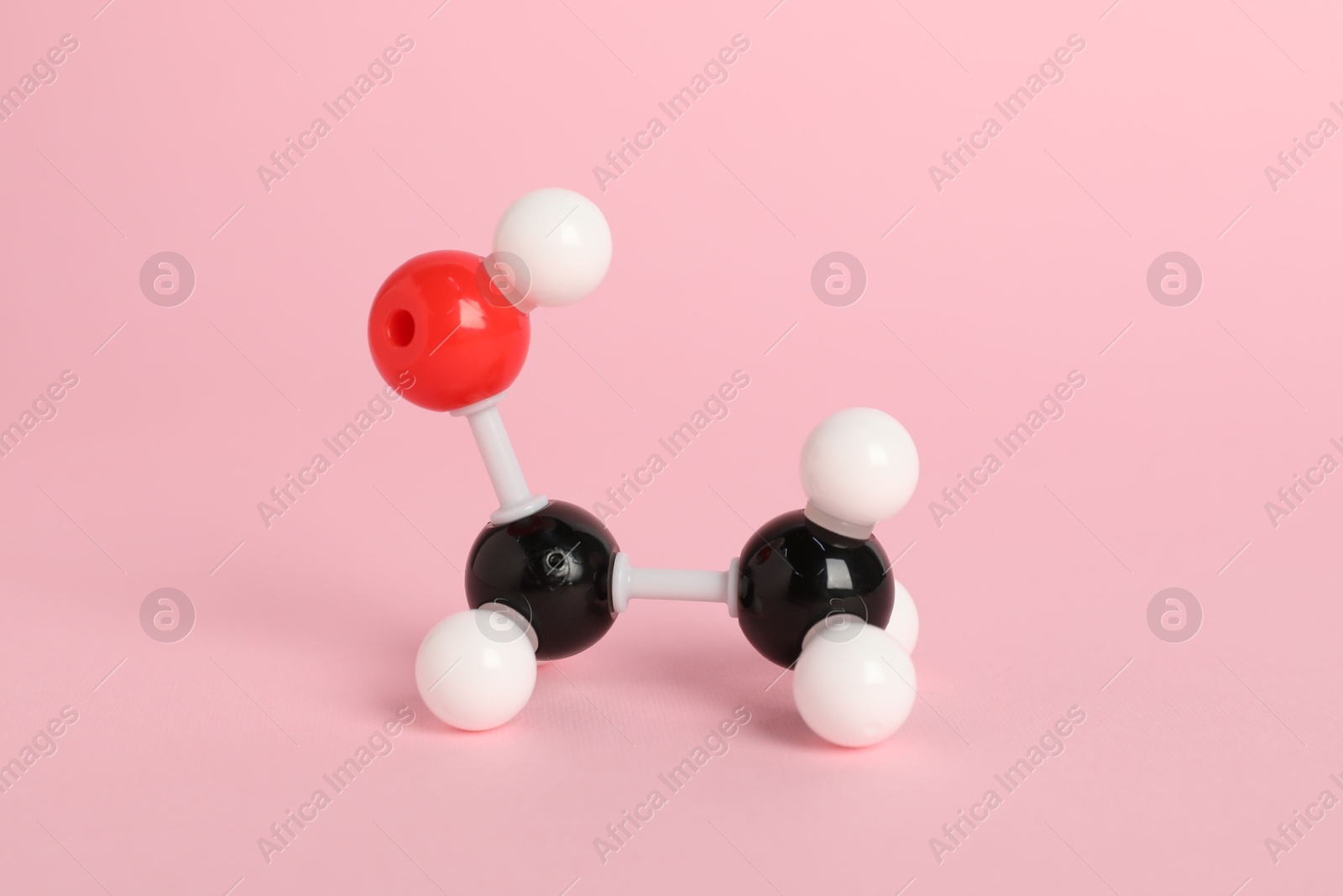 Photo of Molecule of ethanol on pink background. Chemical model