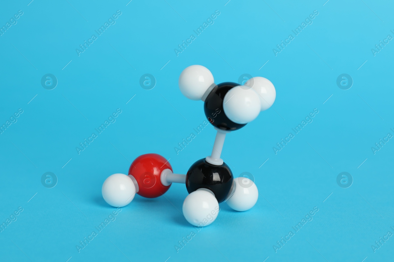 Photo of Molecule of ethanol on light blue background. Chemical model