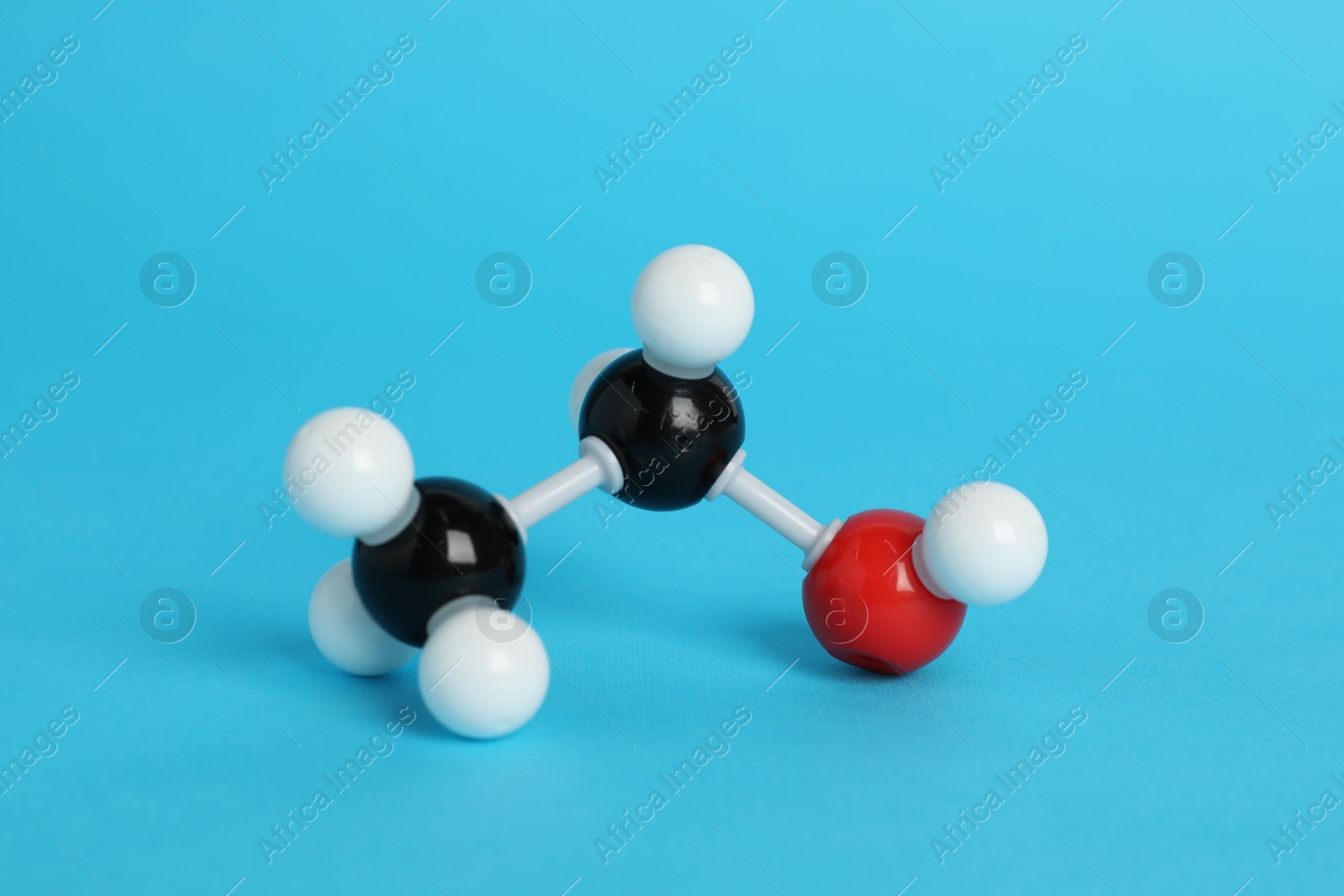 Photo of Molecule of ethanol on light blue background. Chemical model