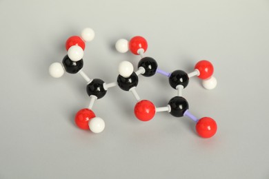 Photo of Molecule of vitamin C on light grey background. Chemical model