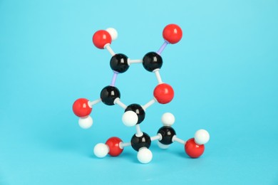 Photo of Molecule of vitamin C on light blue background. Chemical model