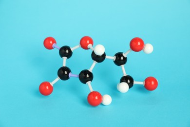 Photo of Molecule of vitamin C on light blue background. Chemical model