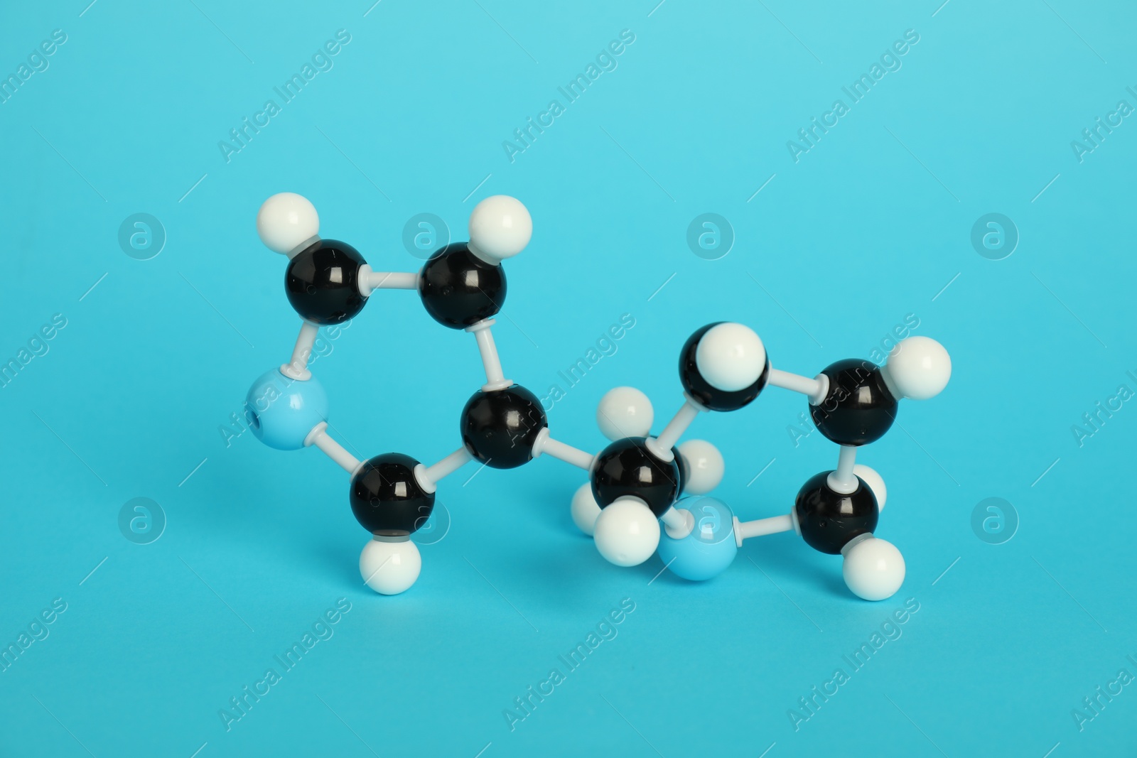 Photo of Chemical model of molecule on light blue background