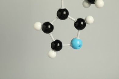 Photo of Chemical model of molecule on light grey background, closeup