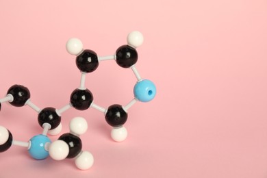 Photo of Chemical model of molecule on pink background, closeup. Space for text